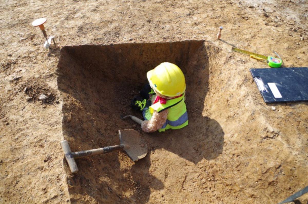 Kent Jones bear archaeologist recording a section on site
