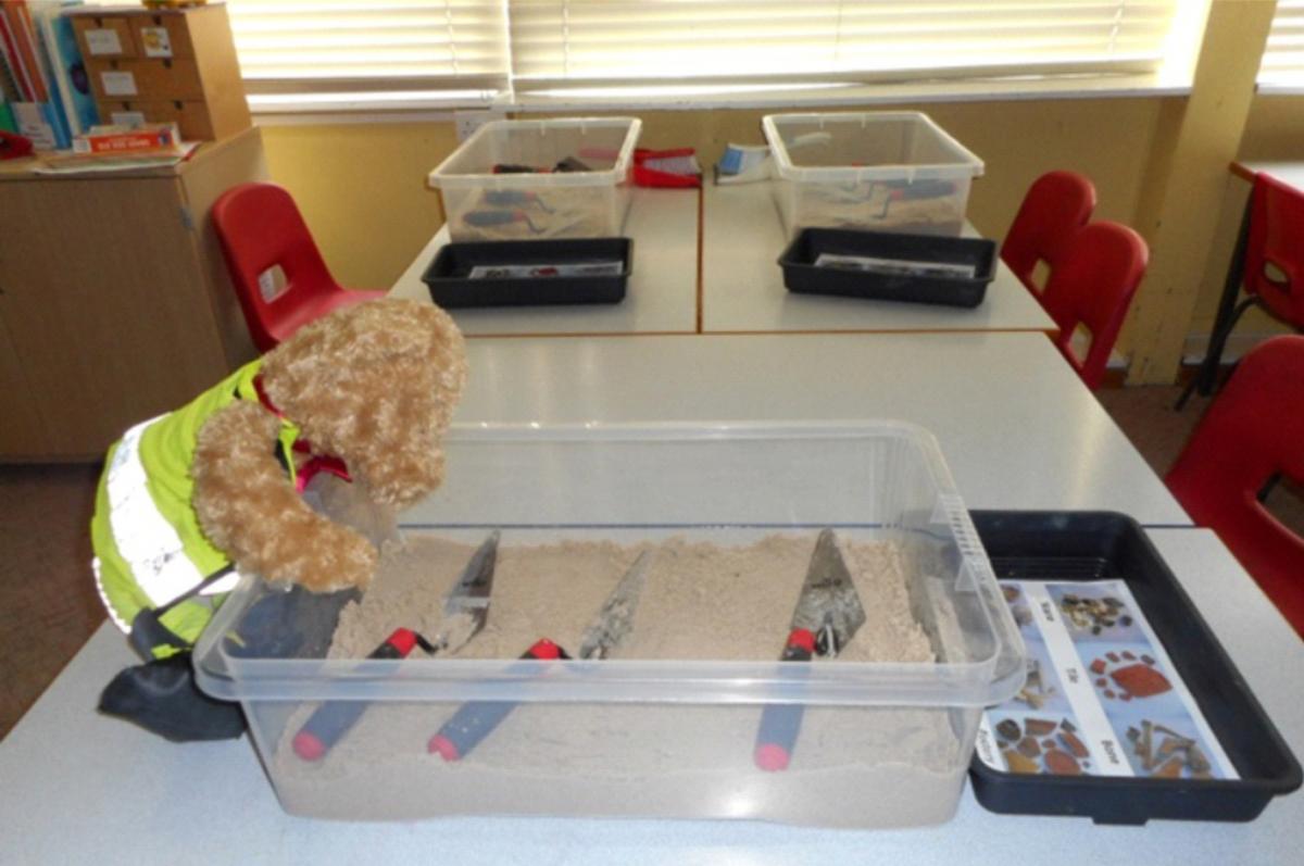 Kent Jones bear archaeologist preparing sandpit activity for school