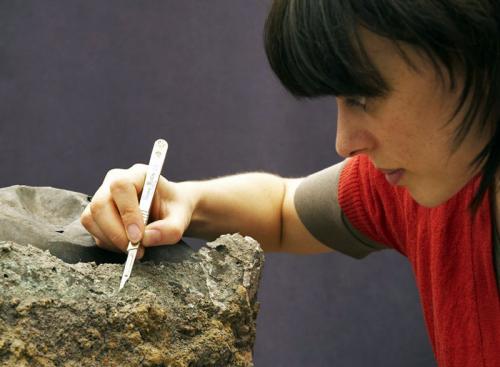 British Museum conservator Alex Baldwin micro-excavating the cauldrons