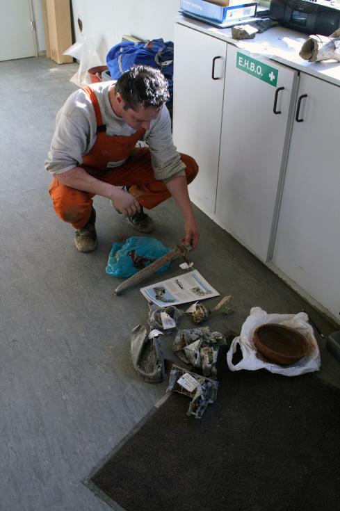 Wharf staff at Kallo Wharf by Antwerp inspect finds from dredging
