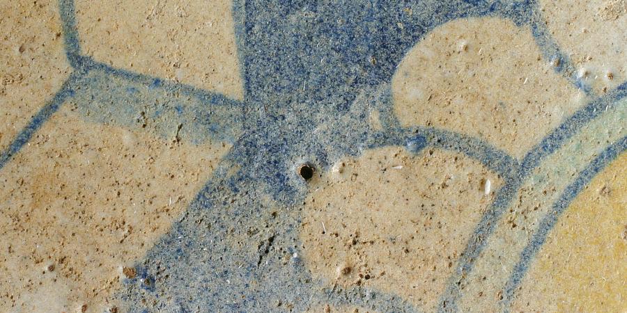 Glazed medieval tile with flower motif