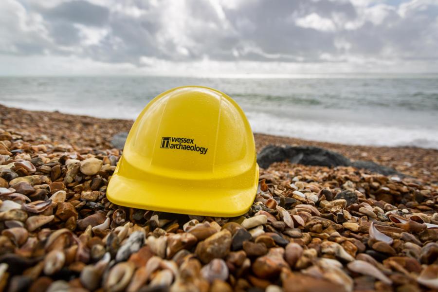 Wessex Archaeology hard hat on the coast