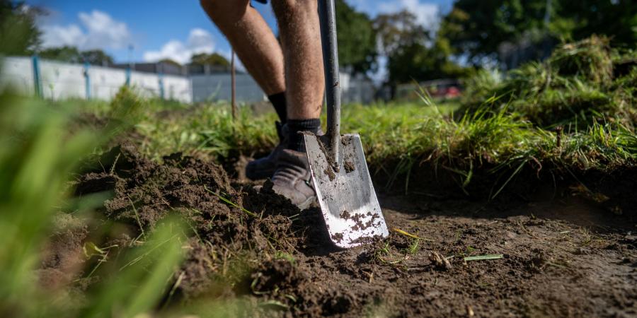 Digging for Erlestoke participant wears steel-toe boots and has their spade ready