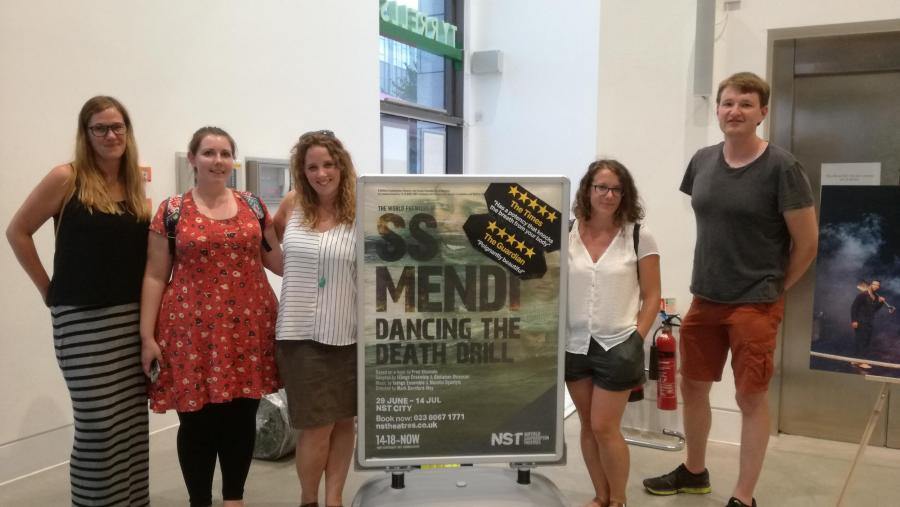 The group next to a SS Mendi: Dancing the Death Drill sign