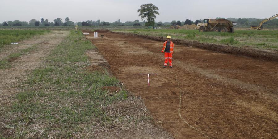Phil Breach standing next to a freshly stripped causewayed enclsoure ditch