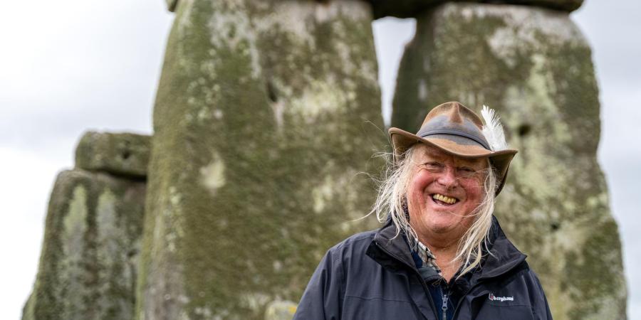 Phil Harding standing in front of the trilithon at Stonehenge
