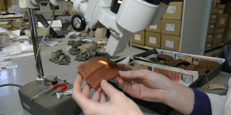 Looking at a piece of pottery from excavations at Tidworth through a microscope