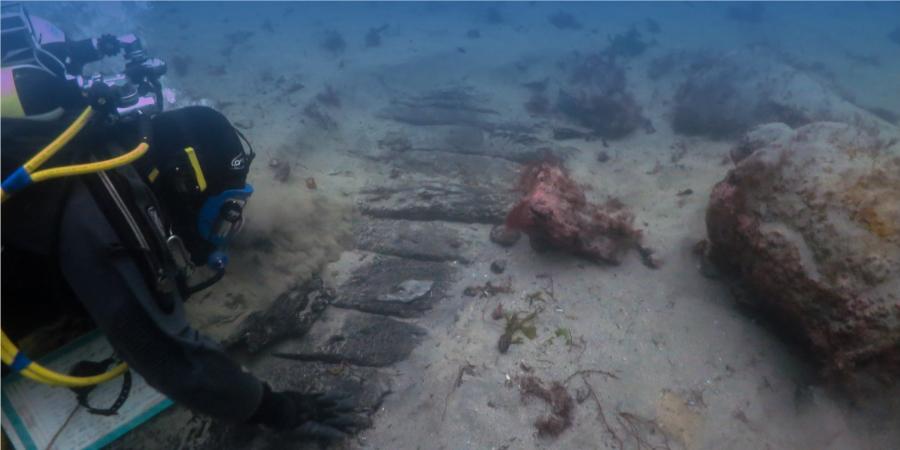 Diver investigating a wreck on the seabed
