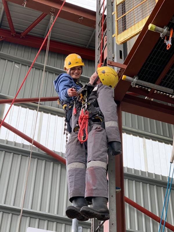 marine archaeologist climbing a ladder