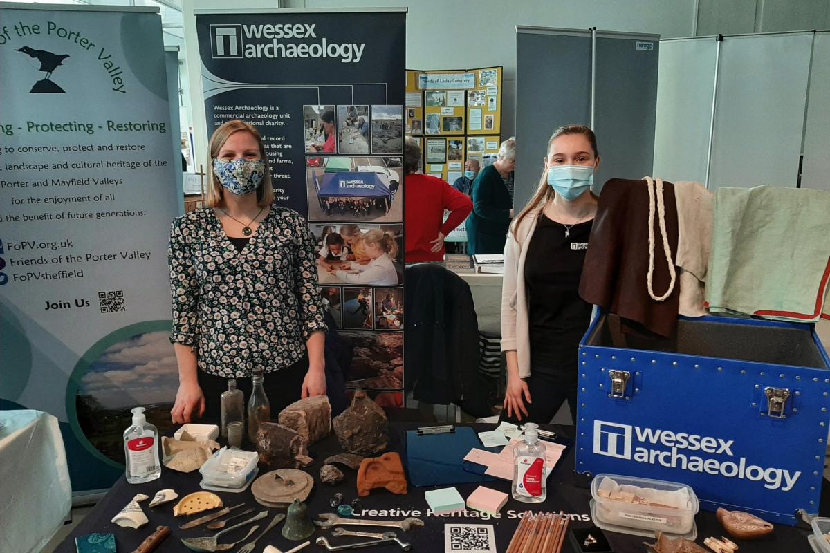 Wessex Archaeology staff with Roman Loan Box and Industrial era artefacts at Sheffield Heritage Fair 2022