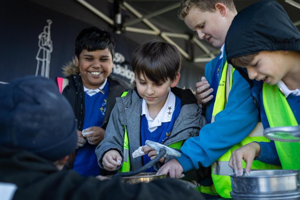 A group of four school children take part in activities on site