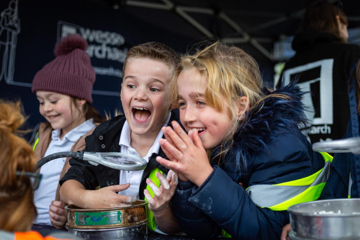 Two school children take part in activities on site