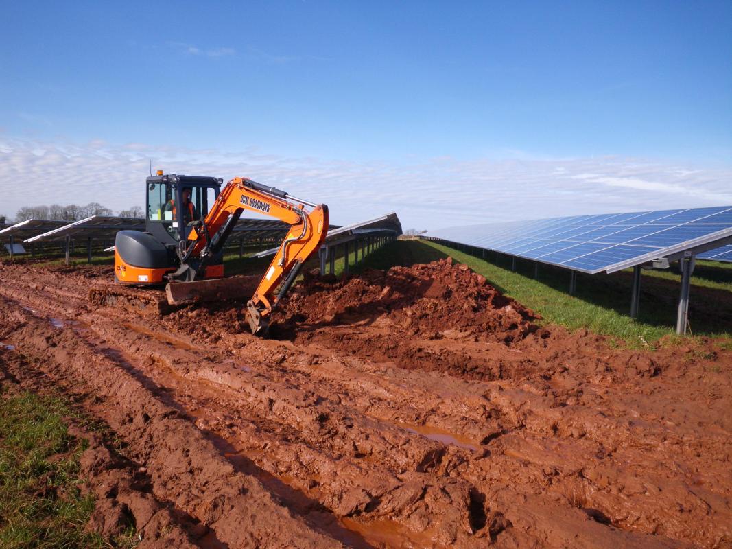 digger and solar panels