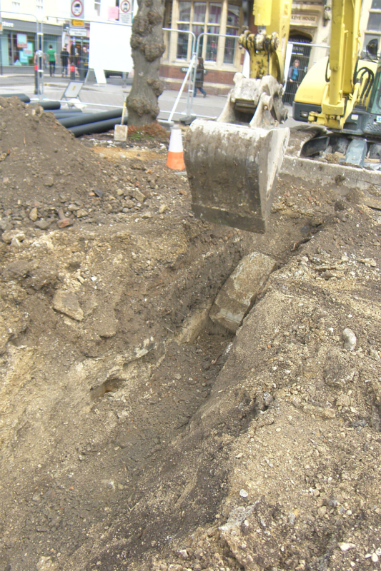Blocks of Chilmark limestone from the demolition of the foundation structure, seen within the excavation trench