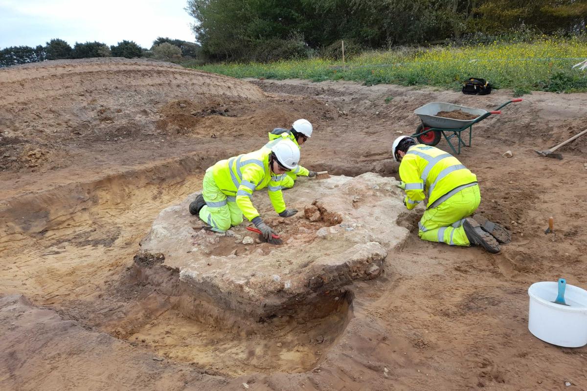 Archaeologists excavate a medieval kiln on site.