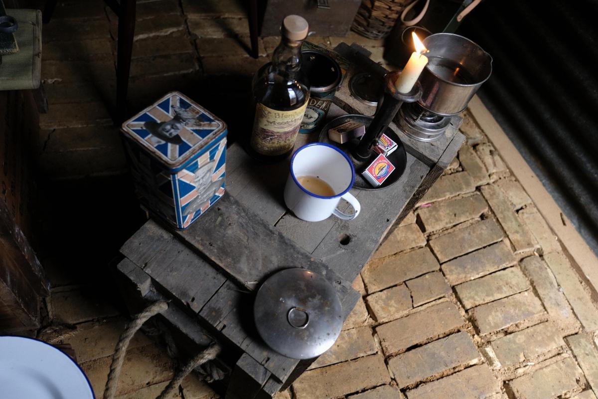 Recreating the past at CEMA - a mug, candle and other options on top of a wooden box in a trench (Credit: James Valls)