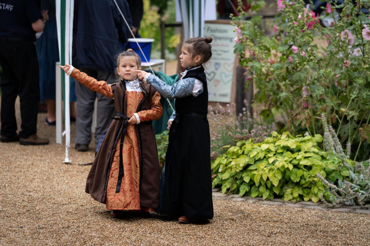 Two children in Tudor costume at the Festival of Archaeology