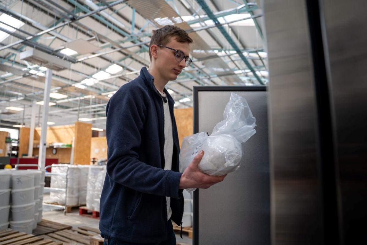 Ed Treasure retrieves a soil sample in the laboratory. 