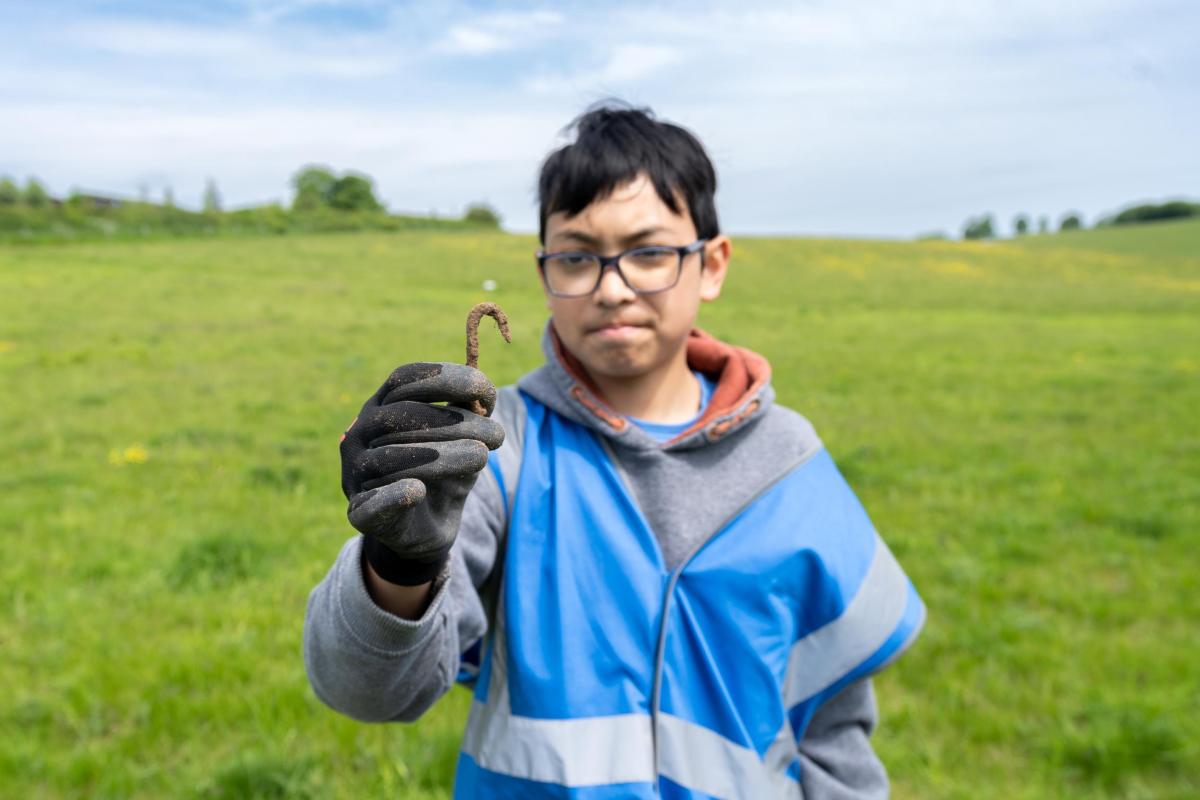 Historic England's Rejuvenate Project.  Discovery of a metal hook found while digging at Coombe Bissett Down Nature Reserve, Wiltshire.