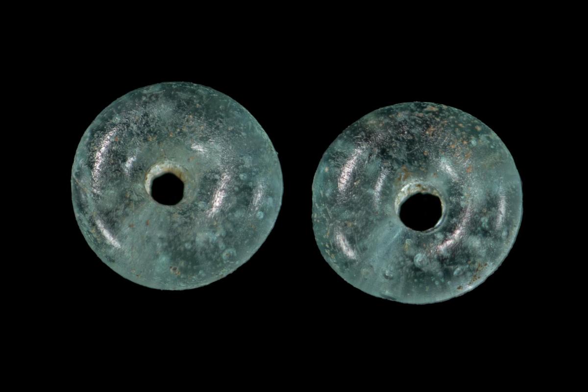 Two doughnut shaped translucent light turquoise glass beads from an Anglo-Saxon burial