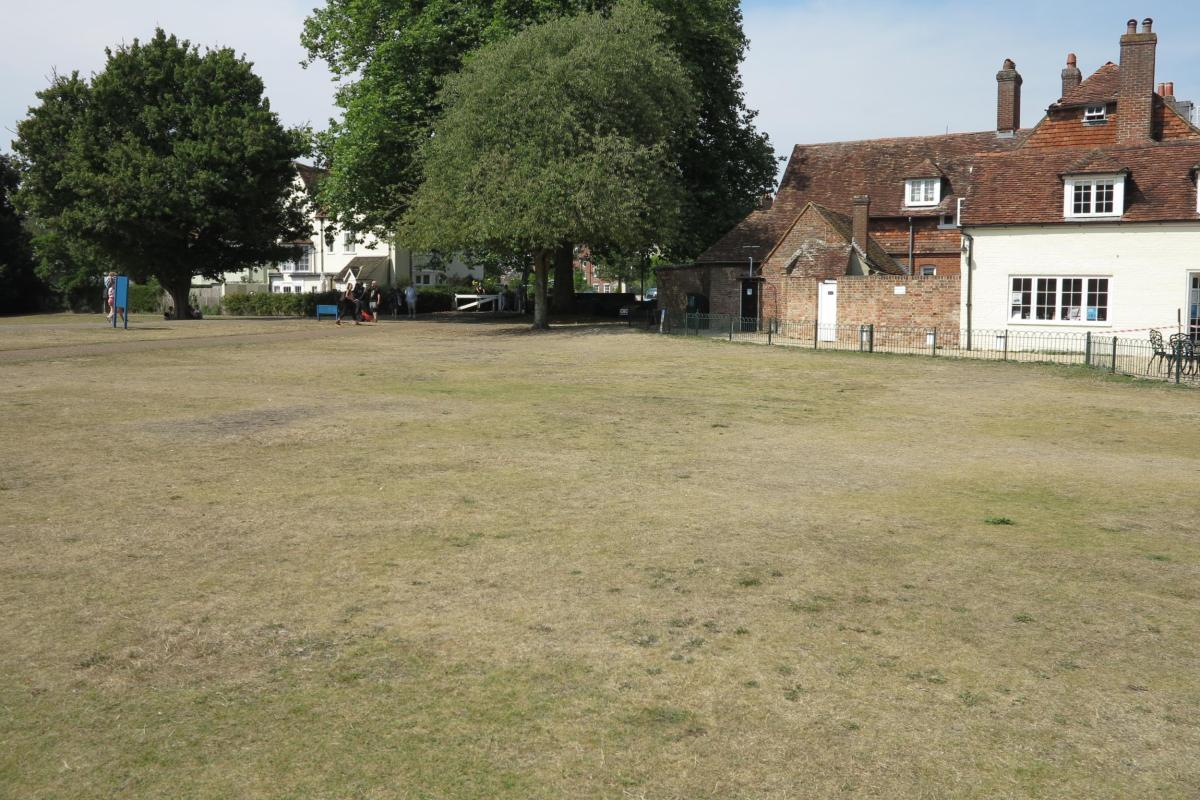 The foundations of the Bell Tower, visible as a parch-mark in grass