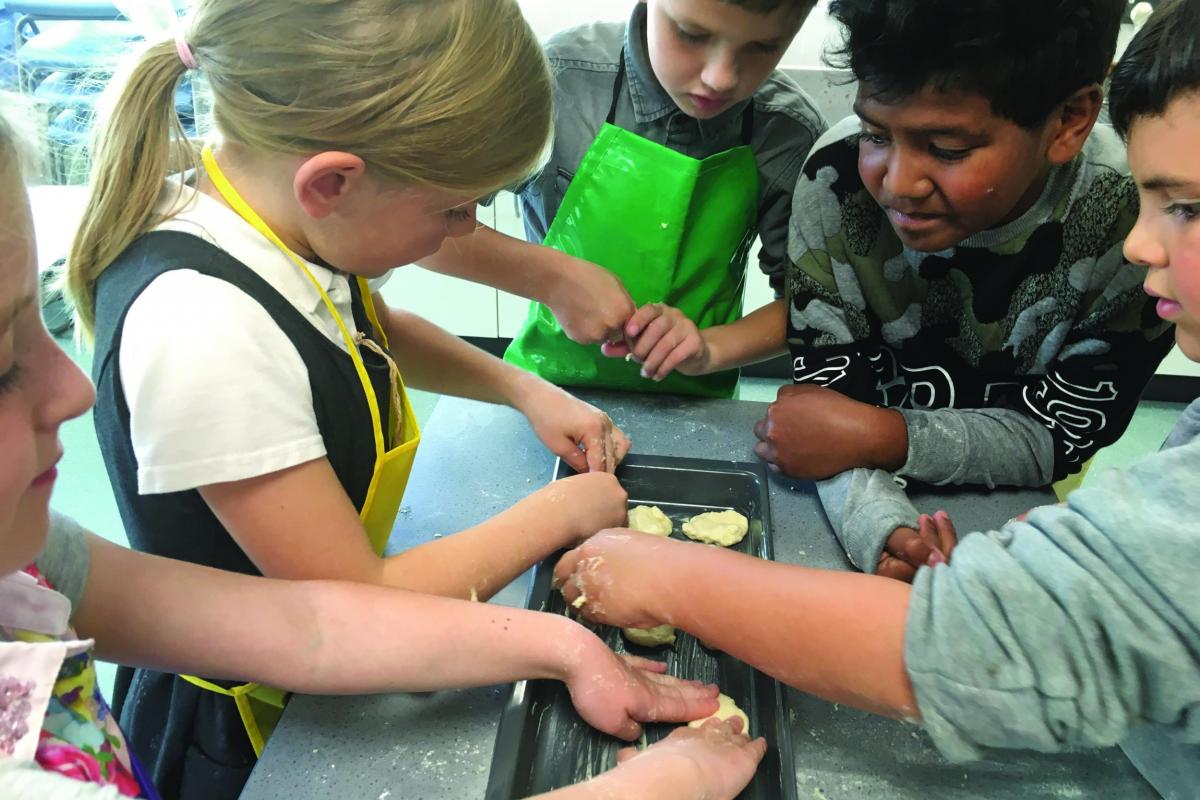 School children learning about baking