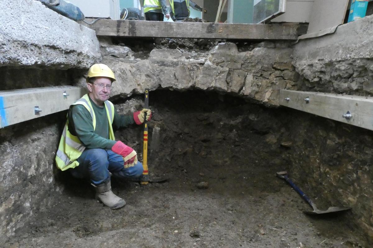 Archaeologist Marek Lewcun underneath the floor at Bath Assembly Rooms.