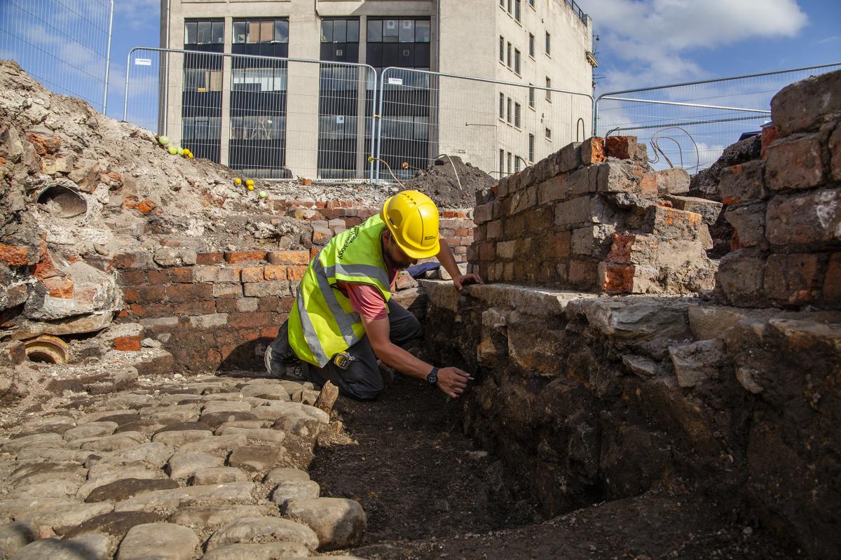 Archaeologist excavating industrial archaeology at Sheffield Castle