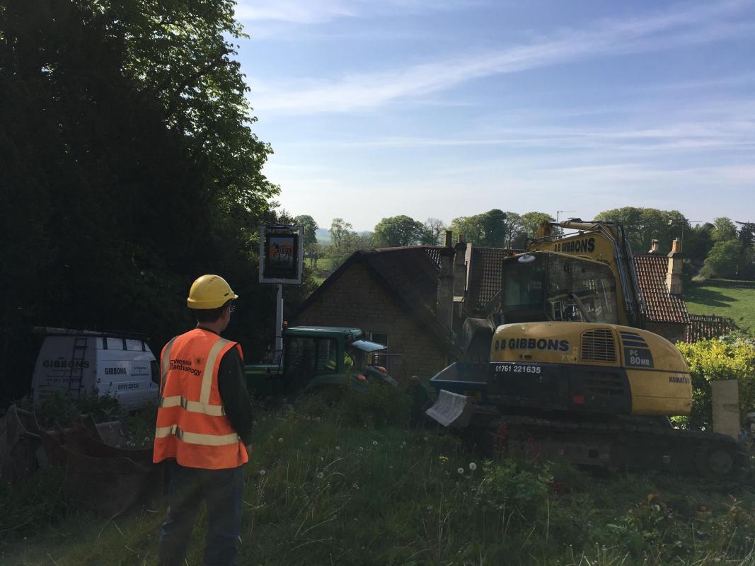 A view of the Packhorse Inn, Bath, with archaeologist in foreground