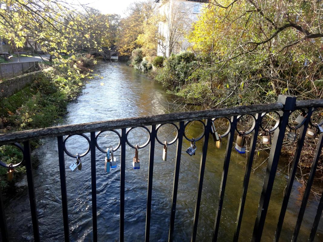 Bridge over river with trees on the river banks 