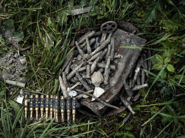 Old, discarded bullet rounds on grass, found by Operation Nightingale at Lost Village of Imber