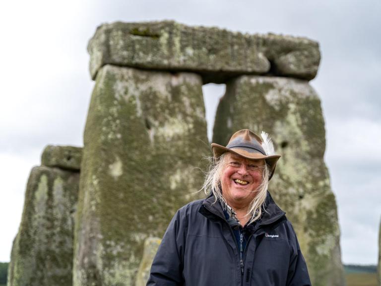 Phil Harding standing in front of the trilithon at Stonehenge