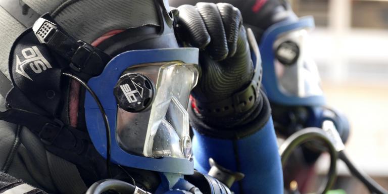 Side view of a diver's head wearing a face mask, before diving.