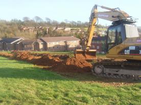 Digger excavating a trench