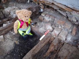 Kent Jones bear archaeologist taking photos on site