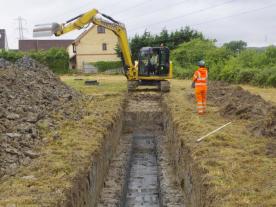 Digger excavating a trench