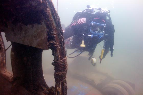 Diver surveying an underwater wreck site